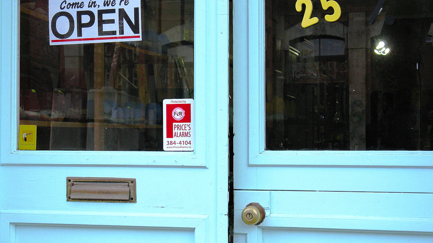 Storefront glass door with an open sign, commercial locksmith in Mason OH
